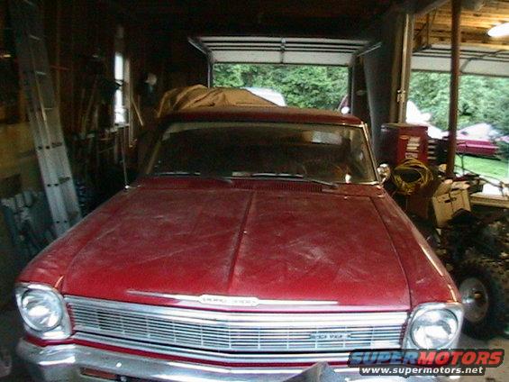 Red 1966 Chevrolet Nova front view in a garage, dusty condition