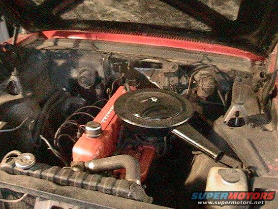 1966 Chevrolet Nova engine bay with red valve covers and black air cleaner