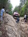 2000 Jeep Cherokee - Jeep Cherokee navigates a challenging off-road obstacle with onlookers present.