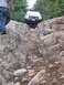 2000 Jeep Cherokee - A 2000 Jeep Cherokee tackles a challenging rocky obstacle on an off-road trail.