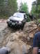 2000 Jeep Cherokee - Jeep Cherokee tackling a challenging off-road obstacle on a wooded trail.