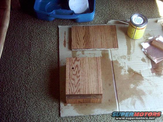 Wood pieces with stain can and sandpaper on cardboard