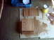 1990 Ford Bronco - Wood pieces are being refinished with stain and sandpaper, with a can of stain nearby.