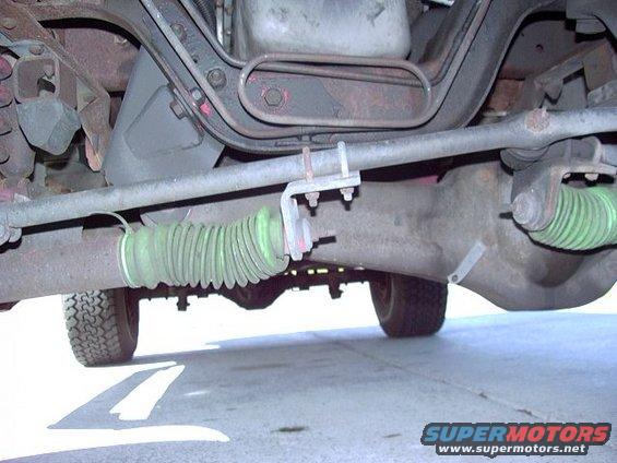 Undercarriage view of a green steering bellows and differential