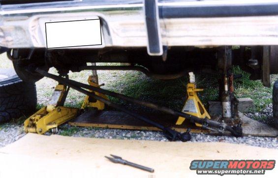 rear of vehicle on jack stands, showing suspension and exhaust components