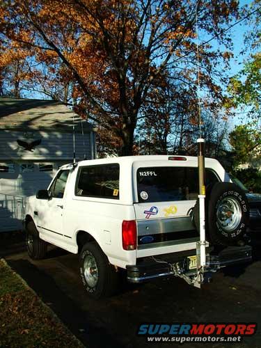 White 1994 Ford Bronco parked outside a house, spare tire mounted on the rear door