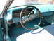 1970 Ford Ranchero - The interior of a classic car features a light blue dashboard and teal carpeting.