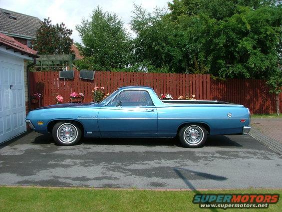 Blue 1970 Ford Ranchero parked in driveway, side view