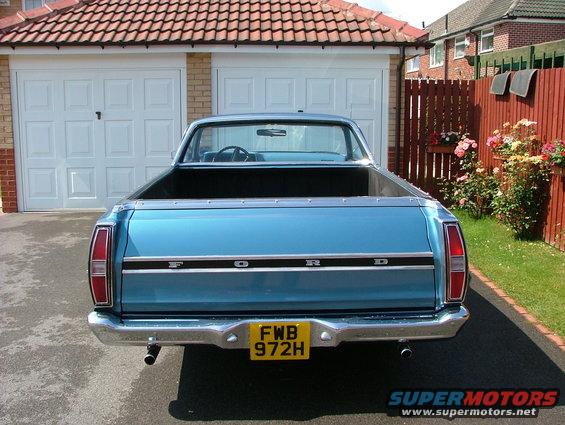 Rear view of a blue 1970 Ford Ranchero with a chrome bumper and yellow license plate
