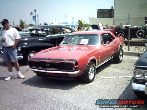 Red 1967 Chevrolet Camaro SS parked next to a black car