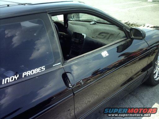Black 1995 Ford Probe interior with 'INDY PROBES' sticker on the driver's side window