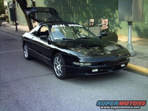 Black 1995 Ford Probe with trunk open, parked on a street