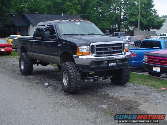 Lifted black 1999 Ford F-250 Super Duty truck, 3q-front view