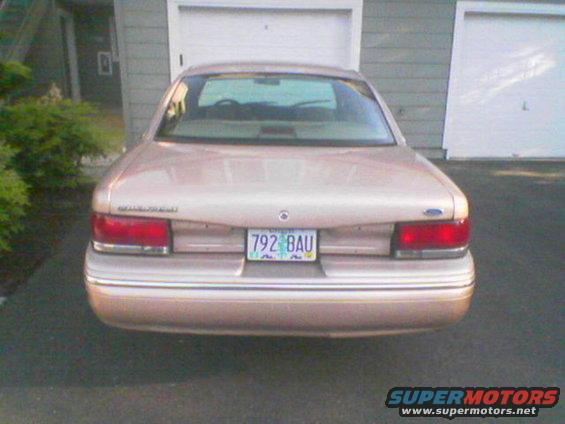 Tan sedan's rear view, 1995 model year indicated by taillights and body style