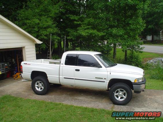 White pickup truck, side view, parked in driveway