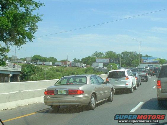 Traffic jam on a highway with multiple cars and trucks, seen from a car