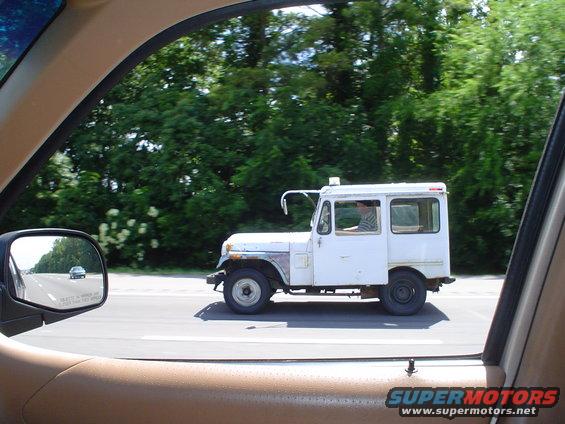 White panel van driving on a highway, seen from inside another vehicle
