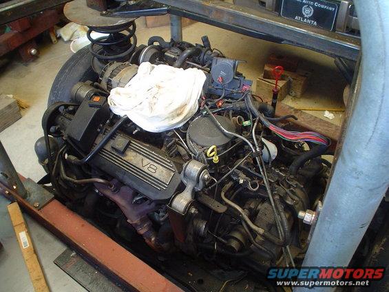 V8 engine with visible wiring and exhaust manifolds