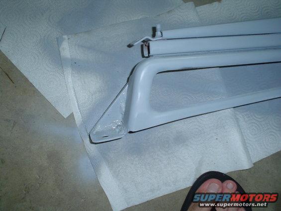 white car part, possibly a grille, on paper towels