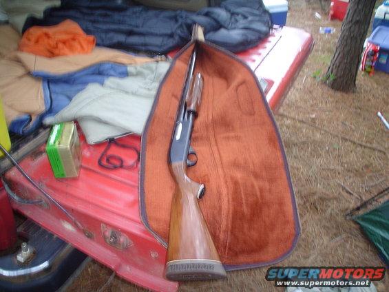 Shotgun in case on red vehicle tailgate