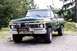 1977 Ford F-150 - This green Ford F-150 pickup truck is equipped with a heavy-duty bull bar and winch on the front.