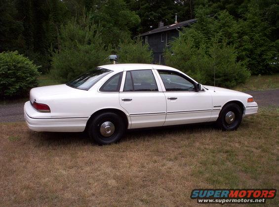 White 1992 Ford Crown Victoria sedan parked on grass, side view