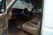 1985 Ford Bronco - The interior of this 1985 Ford Bronco features a tan dashboard, steering wheel, and plush seating.