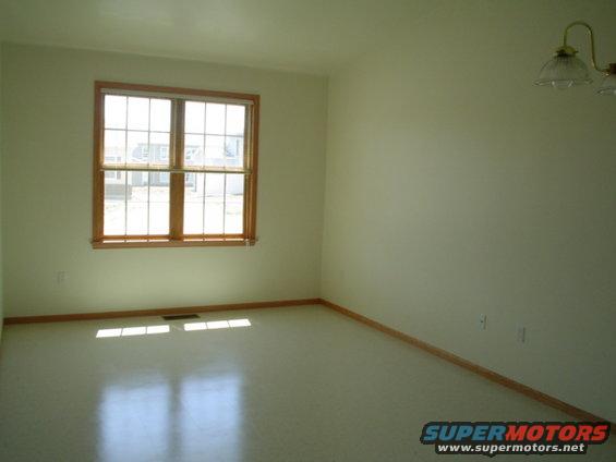 picture-165.jpg Front living room, has our couch, and 2 recliners and TV and a desk for bills and such.