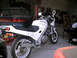 1986 Honda Interceptor - This white 1986 Honda Interceptor motorcycle is seen in a garage setting, with a car visible in the background.