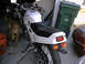 1986 Honda Interceptor - A white 1986 Honda Interceptor motorcycle is parked indoors next to a green trash can and a dog.