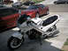 1986 Honda Interceptor - A white Honda motorcycle is parked in front of several cars on a sunny day.