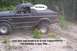 1988 Ford Bronco - This Bronco is off-roading on a dirt path surrounded by trees.