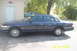 1994 Ford Crown Victoria - Side view of a dark blue sedan, with a teal sedan visible in the background.