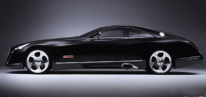 Black coupe with chrome trim and distinctive wheels. Red badge on fender