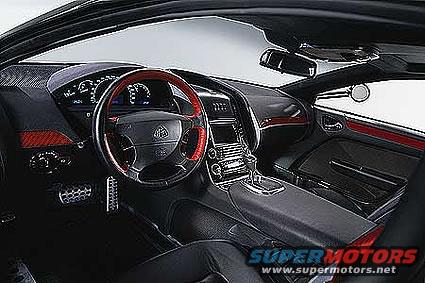 car interior with red-trimmed steering wheel, digital dash, and center console