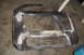 1998 Volkswagen Jetta - Unpainted car bumper section with body filler applied to repair damage.