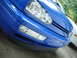 1998 Volkswagen Jetta - The front of a blue car is shown, with a portion of another vehicle visible on the right side.