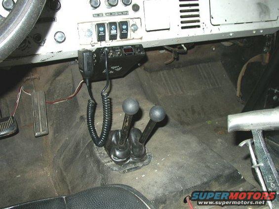 Interior view of a 1978 Ford Bronco showing the dashboard, floor shifter, and pedals