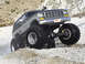 1991 Ford Bronco - This lifted truck, likely from the late 1970s, navigates a rocky, wet terrain with its massive tires kicking up spray.