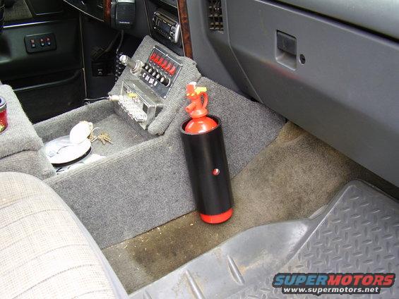 xxx-022.jpg Everybody should have an extinguisher, I just used 3" pvc, screwed to the side of the console, does not ratle out and is available!