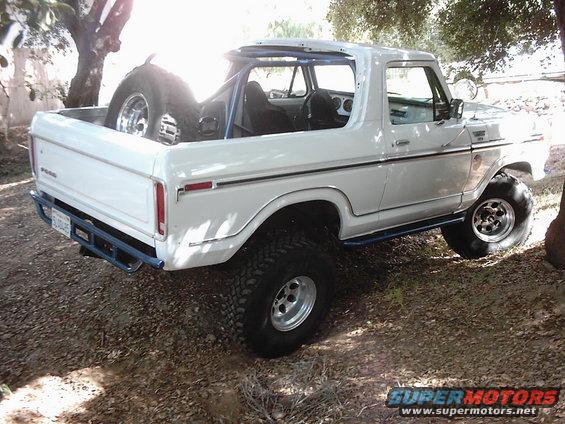 White 1978 Ford Bronco with roll cage and off-road tires