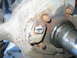 1995 Ford Bronco - A close-up view of a corroded ball joint assembly, showing significant wear and tear.