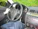 1993 Ford Probe - The interior of a car is visible, with a driver's hand on the steering wheel and the dashboard controls.