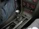 1993 Ford Probe - Close-up of a car's interior, focusing on the manual gear shifter and the center console with climate controls.
