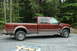 2006 Ford F-350 - 2006 Ford F-350 King Ranch pickup truck parked outdoors with trees in the background.