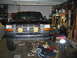 1995 Ford Bronco - This black Ford truck, likely a 1992 model, is undergoing maintenance in a cluttered garage.