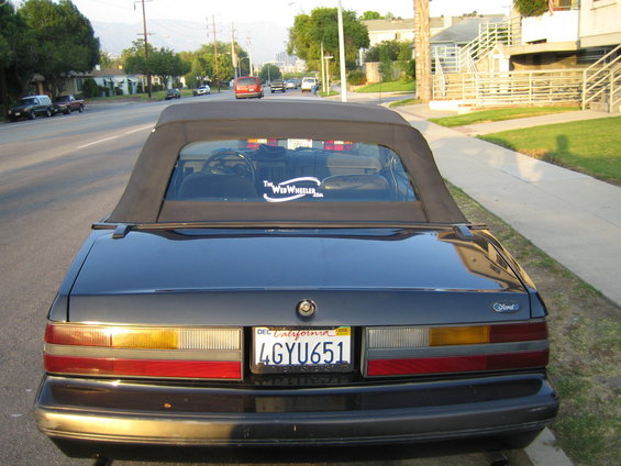Dark 1985 Ford Mustang convertible rear view with California license plate