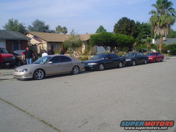 1998 Mercury Sable and other sedans parked on a street in front of houses