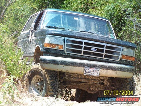 Green 1992 Ford Bronco on a dirt trail, front view. License plate K36-SKT