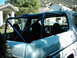 1978 Ford Bronco - The interior of a classic SUV is shown with a prominent blue roll cage installed.